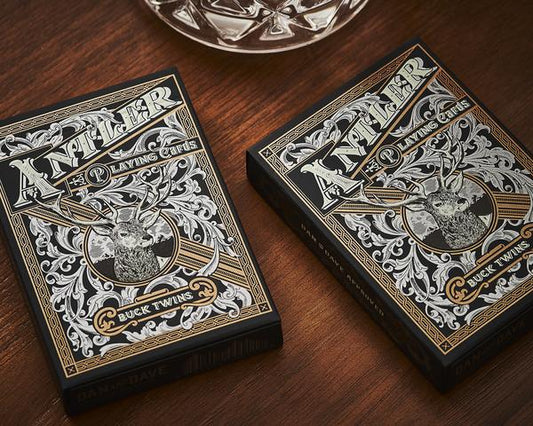 Antler playing cards boxes with antler buck twins artwork, black and gold accents