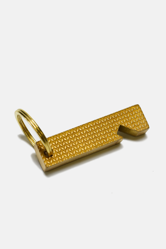 Brass bottle opener by Curated Basics, featuring a sleek, durable design suitable for opening bottled beverages.
