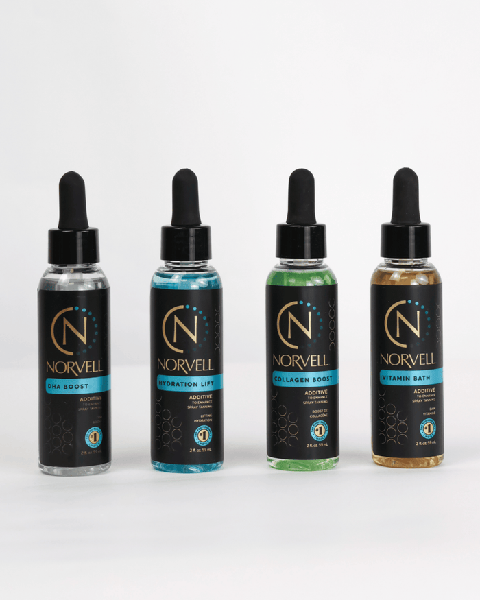 Four Norvell liquid dropper bottles lined up on a white background, showing different additives: DHA Boost, Hydration Lift, Collagen Boost, and Vitamin Bath.